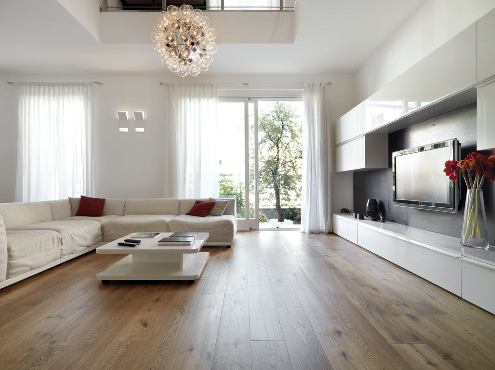 internal view of a modern living room with wood flooring overlooking on the garden